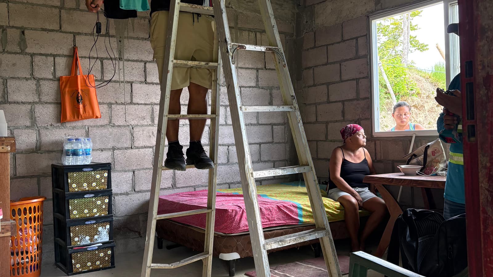 A family watching the install from inside their home.