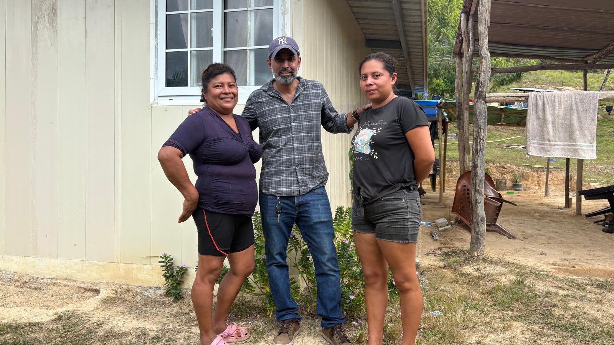 A family standing outside their home.