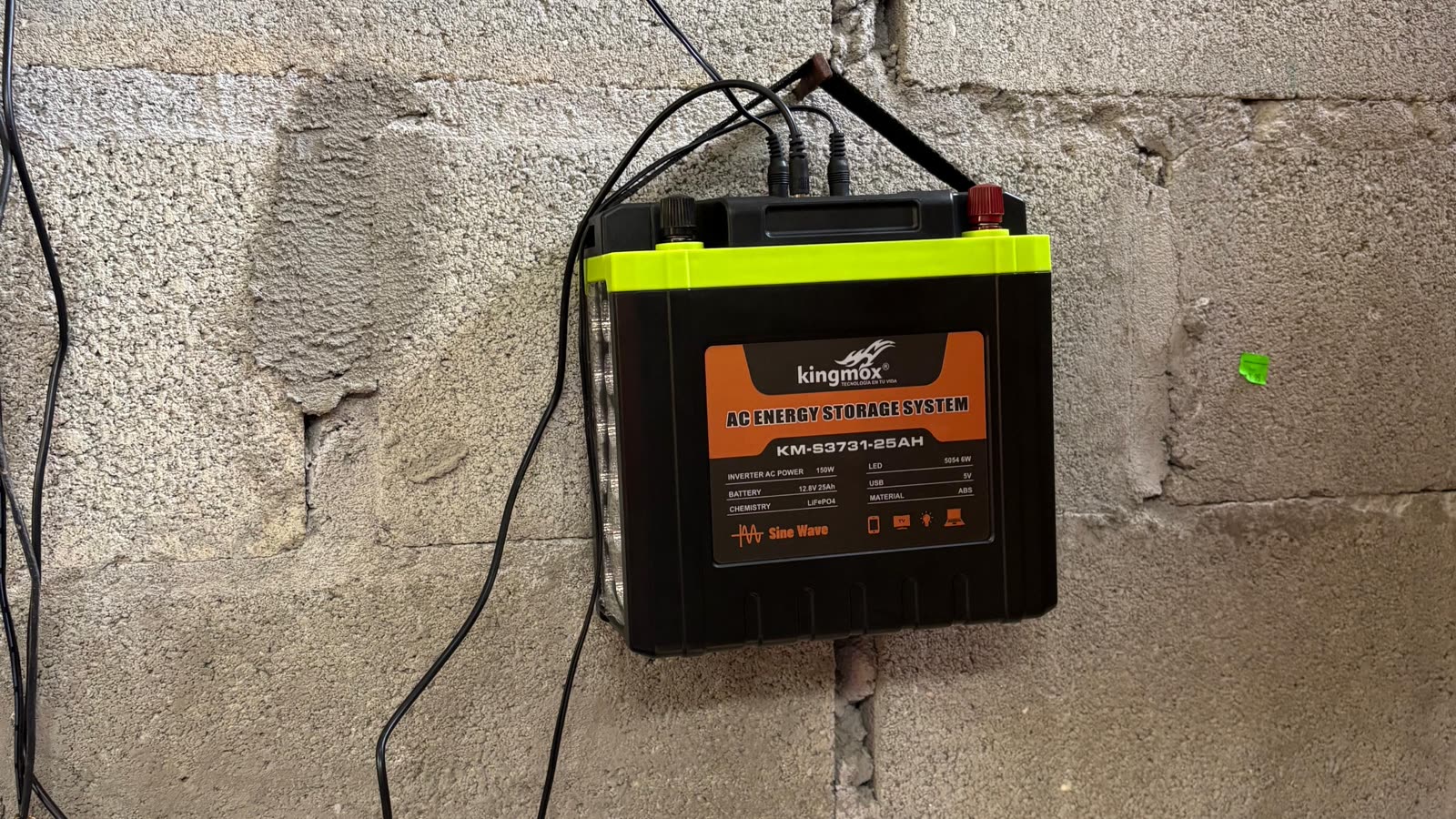 The battery and charge controller mounted on the wall of a home.